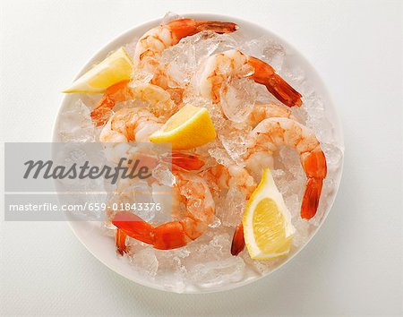 Shrimps with lemon on crushed ice