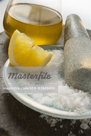 Coarse salt with pestle, lemon and olive oil