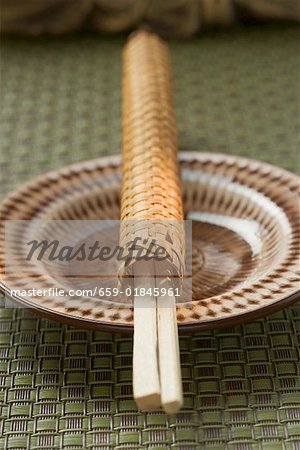 Chopsticks in woven case on plate