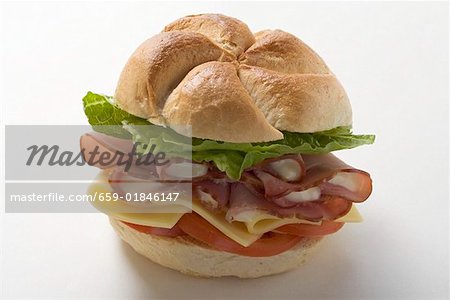 Ham, cheese, tomato and lettuce in a bread roll