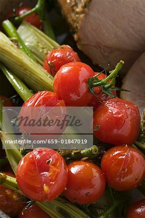 Roast pork with cherry tomatoes and celery (close-up)