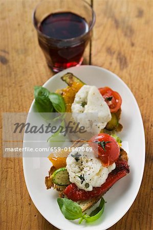 Antipasti with stockfish and glass of red wine (Italy)