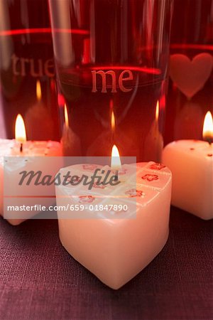 Burning heart-shaped candles for Valentine's Day