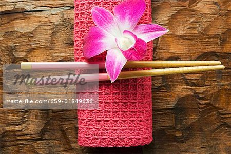 Accessoires de la table asiatique : main serviette, baguettes et orchidée