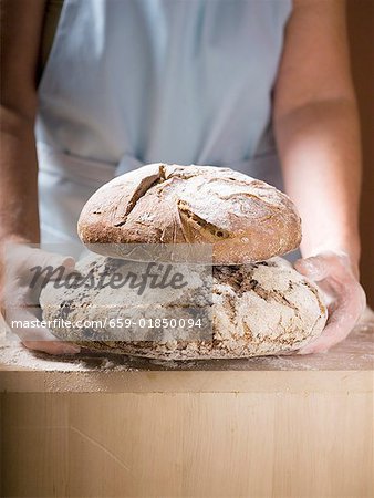 Femme tenant deux pains, Bauernbrot (pain de ferme allemande)