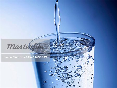 Wasser in ein Glas gießen