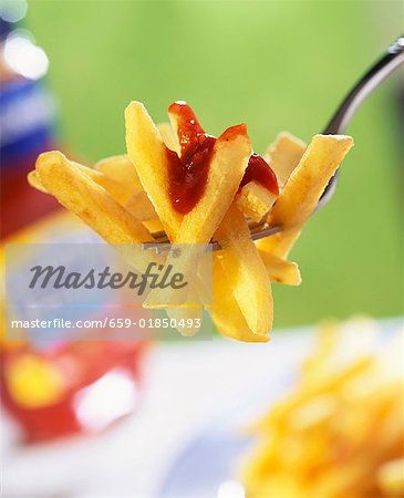 Chips with ketchup on fork