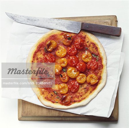 A tomato pizza (with cocktail tomatoes)