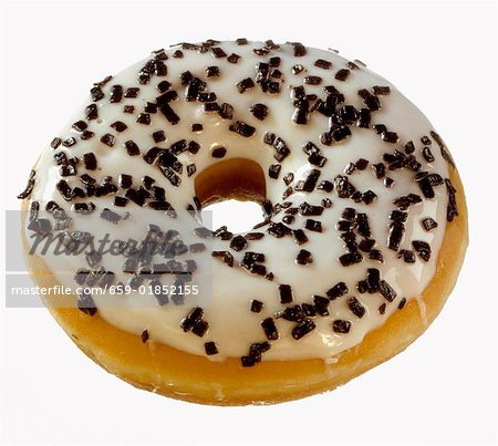 Doughnut decorated with glacé icing and chocolate sprinkles