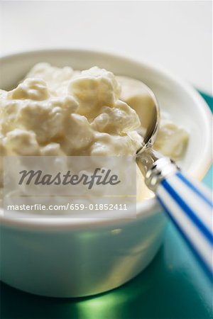 Cottage cheese in a small bowl with spoon