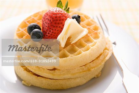 Waffles with butter and berries for breakfast