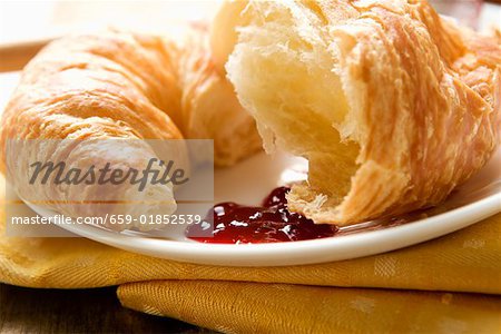 Croissant with jam on a plate