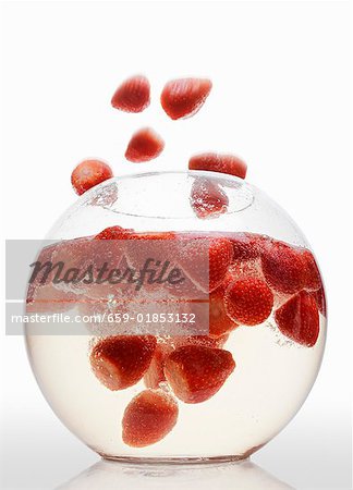 Strawberries falling into strawberry punch