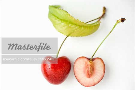A halved cherry with leaf