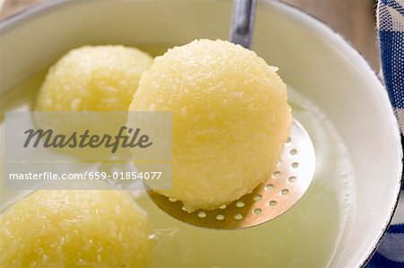 A potato dumpling on a skimmer