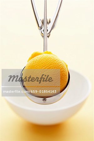 Mango sorbet in an ice cream scoop