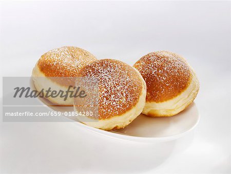 Three doughnuts on a serving plate