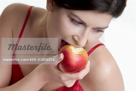 Woman biting into an apple