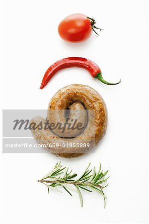 A coiled sausage with rosemary, chilli and tomato