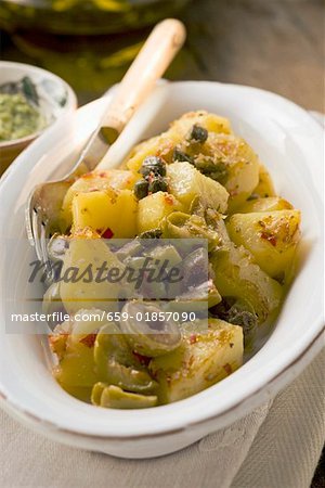 Spicy fried potatoes with olives and capers
