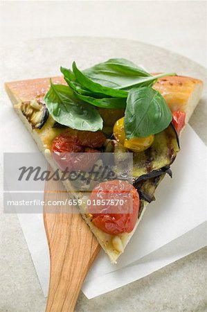 Slice of pizza with aubergines, cherry tomatoes & basil