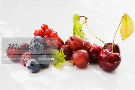 Assorted berries and three cherries with leaves Assorted berries and three cherries with leaves