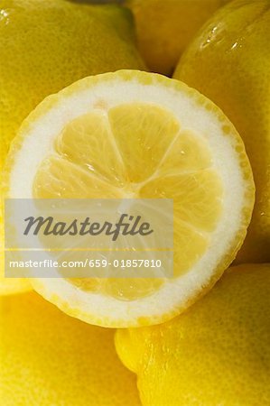 Lemon half on whole lemons (close up)