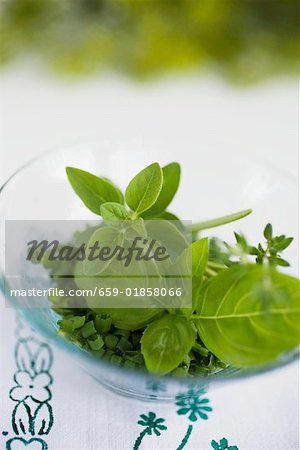 Assorted herbs in glass bowl