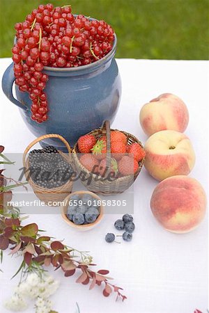 Summer fruit still life on table in garden Summer fruit still life on table in garden