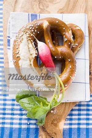 Soft pretzels and radish on tea towel