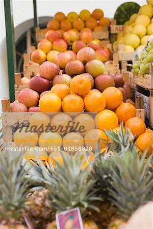 Fruit stall with oranges, pineapples and apples