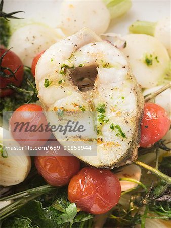 Grilled sea bass cutlet on roasted cherry tomatoes