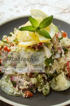 Couscous salad with vegetables, lemon and mint