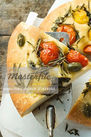 Pizza with cherry tomatoes, capers & rosemary (slice on server)