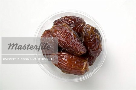 Dried dates in plastic dish