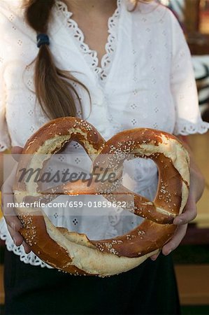 Woman holding giant pretzel at Oktoberfest