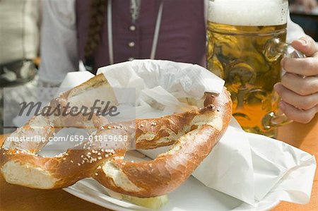 Woman with litre of beer and pretzel at Oktoberfest