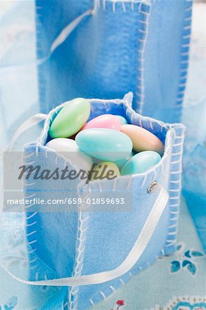 Sugared almonds in blue felt bag