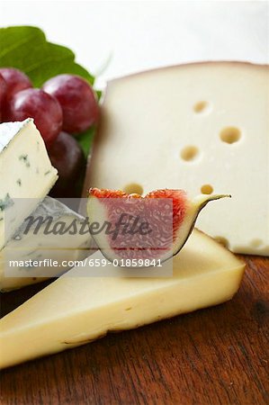 Cheese still life with fig and grapes