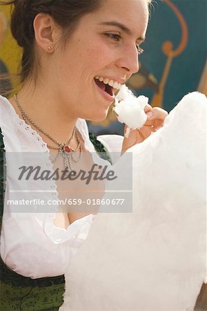 Woman eating candyfloss (Oktoberfest, Munich)