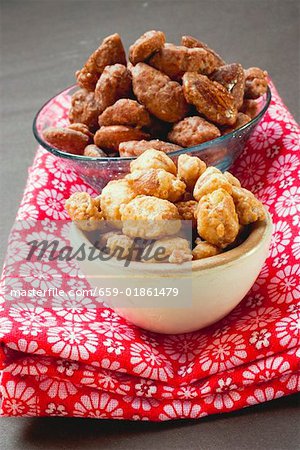 Assorted nuts to nibble in bowls on patterned cloth