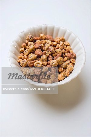 Mixed nuts to nibble in white bowl