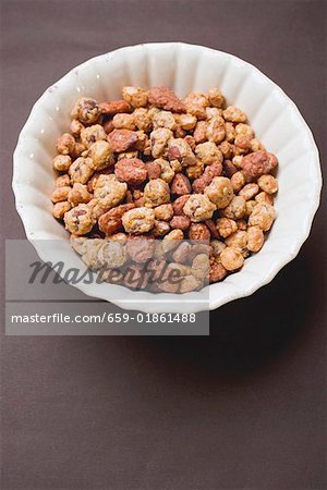 Mixed nuts to nibble in white bowl