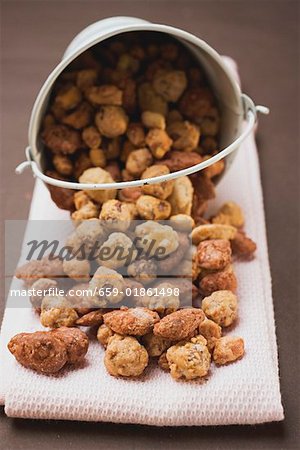 Mixed nuts to nibble in and in front of white bucket