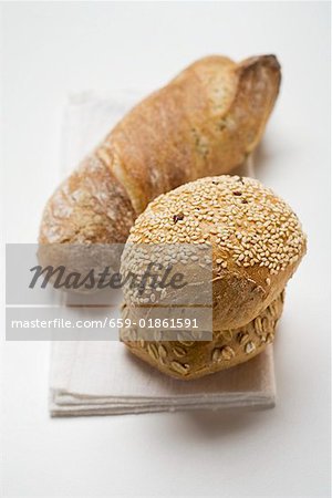 Three different wholemeal rolls on linen cloth