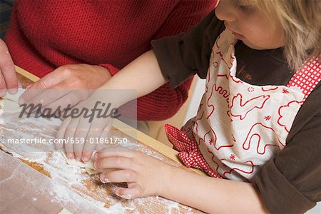 Mother and child folding puff pastries