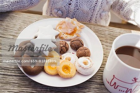 Plate of biscuits and cup of cocoa, child in background