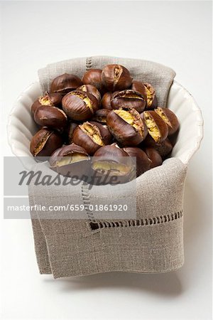 Roasted chestnuts on cloth in white bowl