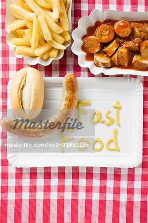 Sausage with bread roll and mustard, Currywurst with chips