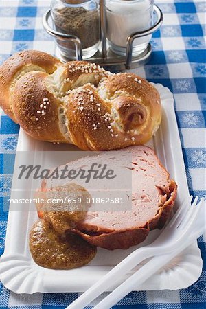 Leberk0se with mustard & pretzel plait on paper plate